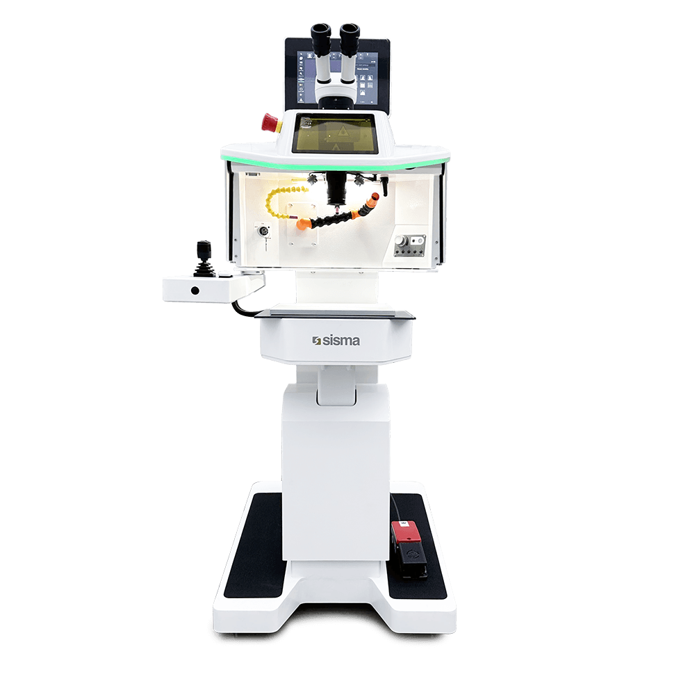Una máquina de soldadura láser Sisma de color blanco, con pantalla, panel de control, dos oculares de microscopio y un pedal, fotografiada sobre un fondo liso.