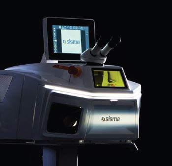 Una máquina industrial de la marca Sisma con pantalla de visualización y accesorio de microscopio, iluminada sobre un fondo oscuro, diseñada para la soldadura láser en la automoción.
